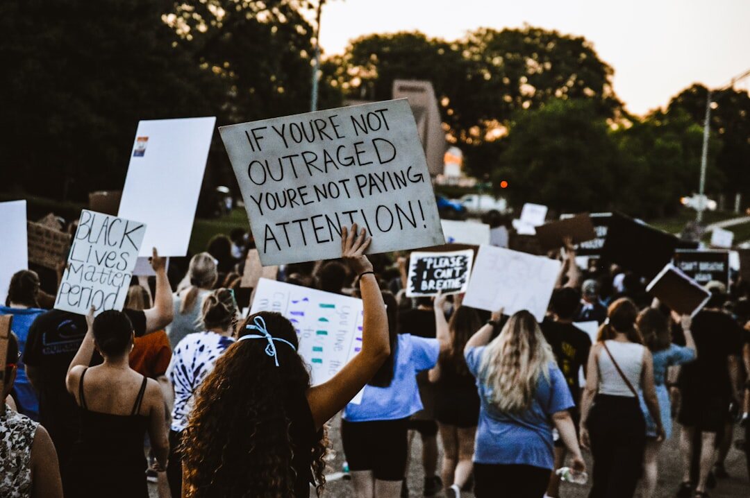 crowd at protest with signs
